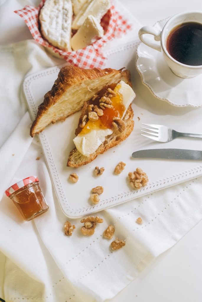 Sliced Croissant on White Surface beside a Coffee Drink